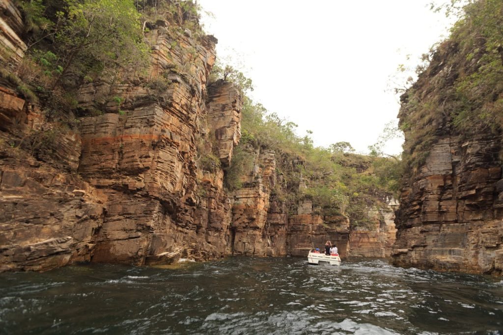 Explore a breathtaking boat ride through rugged canyon landscapes with towering cliffs.